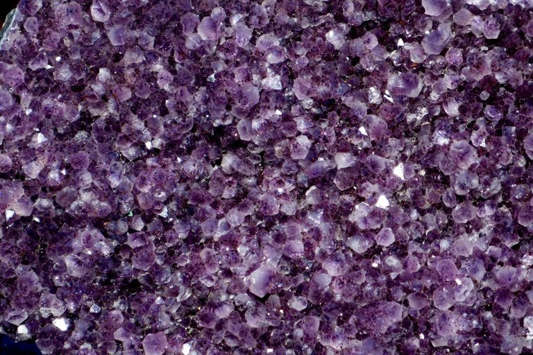Close view of pale and deep purple amethyst crystals